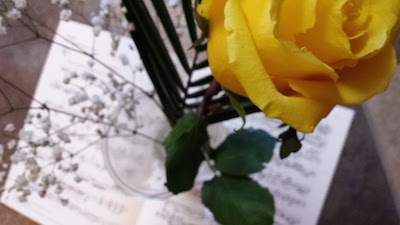 yellow rose above sheet music