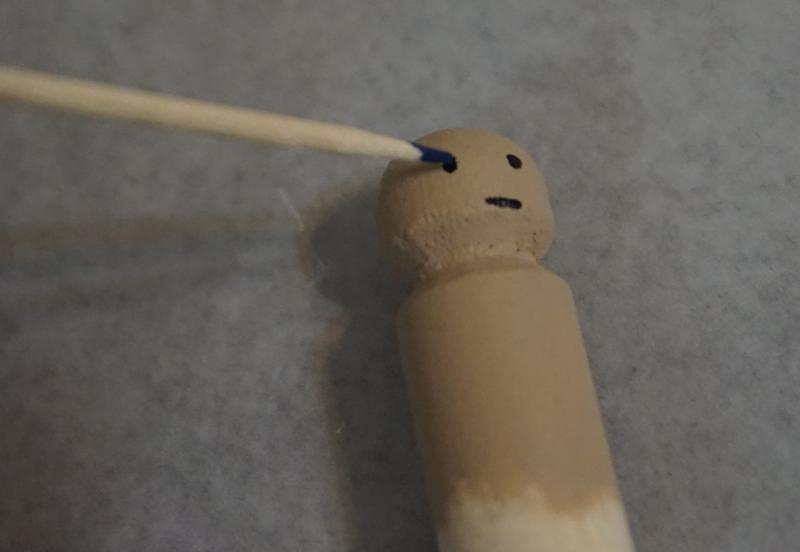 Paint on the end of a toothpick dots an eyeball.
